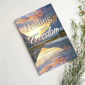 Healing and Freedom book with lavender stems sitting on top
